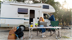 An RV parked long-term at a campsite, representing usage as a cost factor.